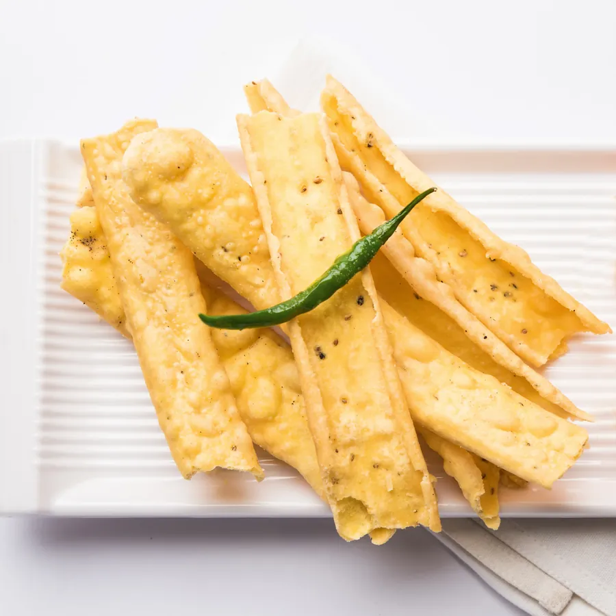 Crisp fafda strips with a fried green chilli